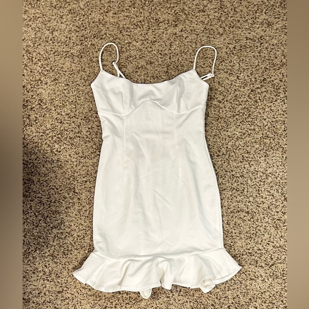 cute simple little white dress with ruffles at the bottom!